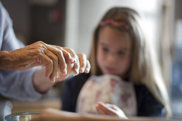 Cropped image of woman with granddaughter making food in kitchen - CAVF40476