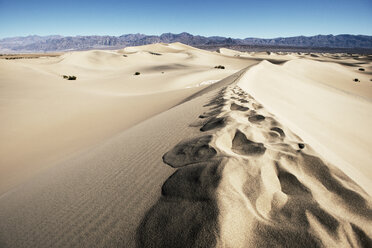 Scenic view of sand by mountains against clear blue sky - CAVF40597