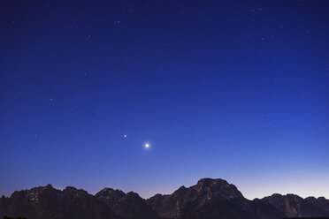 Scenic view of snowcapped mountains against sky at dusk - CAVF40667