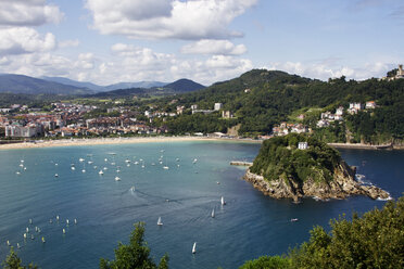 High angle view of boats sailing on sea by city and mountains against sky - CAVF40717