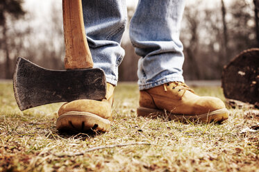 Low section of lumberjack with pick axe on field - CAVF40741