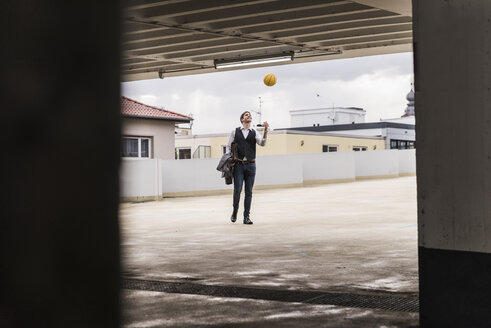 Geschäftsmann wirft Basketball im Parkhaus auf - UUF13449