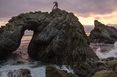 Woman standing on rock formation at Big Sur - CAVF40920