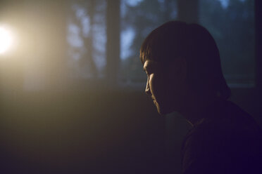 Side view of thoughtful man sitting at home - CAVF41263