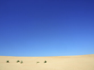 Scenic view of desert against clear blue sky - CAVF41373