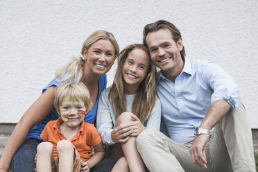 Portrait of happy two generation family sitting at yard - MASF04702