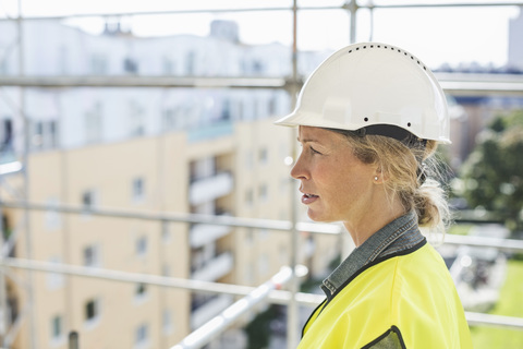 Side view of female architect at construction site stock photo