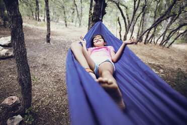 Girl lying on hammock in forest - CAVF41725