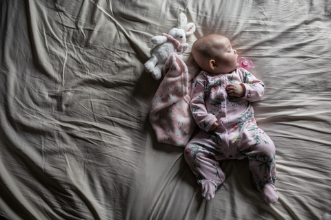Draufsicht auf ein schlafendes Mädchen im Bett, lizenzfreies Stockfoto