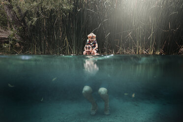 Father carrying son on shoulders while swimming in lake - CAVF42555