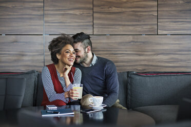 Happy business couple having drinks in restaurant - CAVF42658