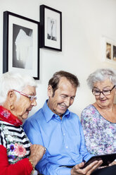 Happy senior people using digital tablet at nursing home - MASF04951