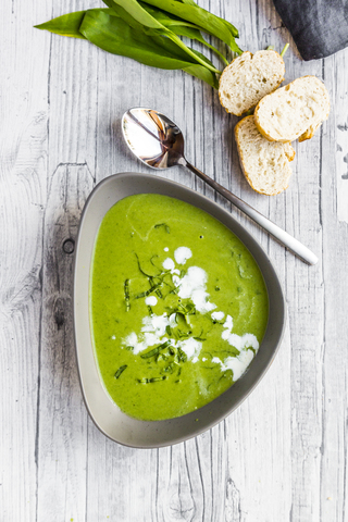 Bowl of ramson soup garnished with ramson and cream stock photo