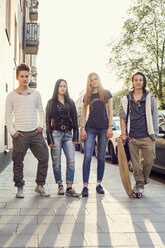 Full length portrait of confident high school students standing on sidewalk - MASF05004