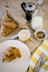 Italian cornetto on plate, French press and cappuccino - GIOF03913