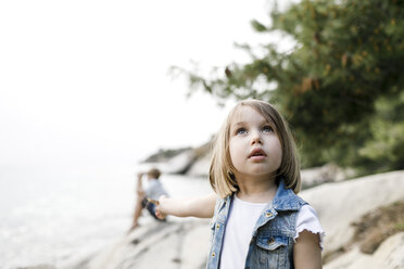 Portrait of little girl looking up - KMKF00169