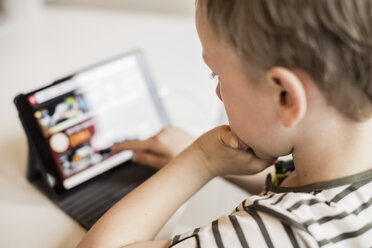 Close-up of boy using digital tablet at table - MASF05191