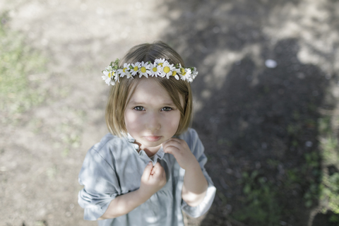 Portrait of blond little girl wearing flowers stock photo