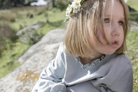 Portrait of blond little girl wearing flowers stock photo