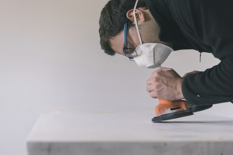 Man sanding door stock photo