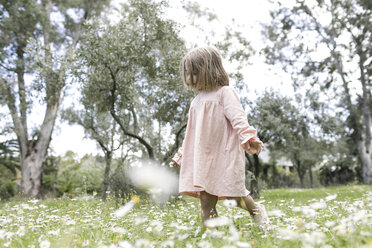 Little girl walking on flower meadow - KMKF00198