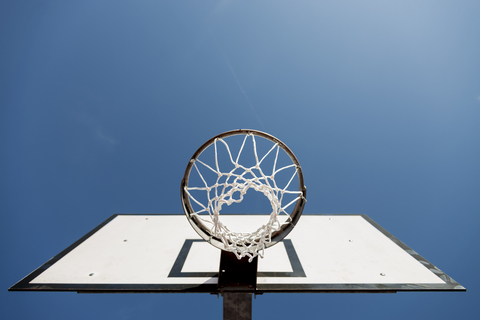 Basketball hoop against blue sky stock photo