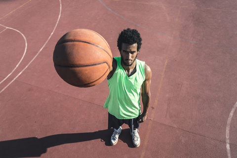 Young basketball player holding ball stock photo