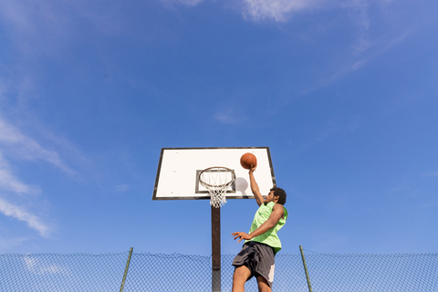 Young man playing basketball stock photo