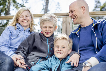 Portrait of happy boys with mother and father outdoors - MASF05476