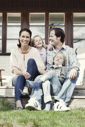 Portrait of happy family of four enjoying in yard - MASF05483