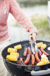 Midsection of woman barbecuing outdoors - MASF05527