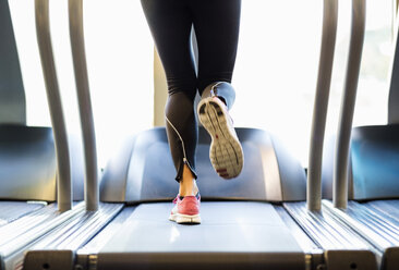 Low section of woman exercising on treadmill - MASF05564