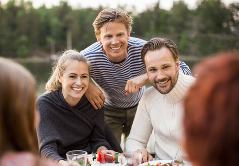 Happy friends enjoying meal outdoors - MASF05579