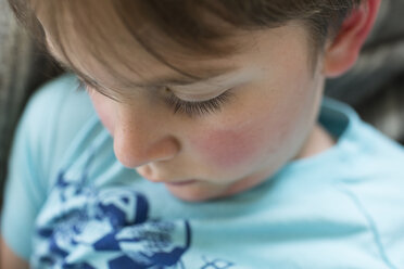 Close-up of boy sitting at home - CAVF43049