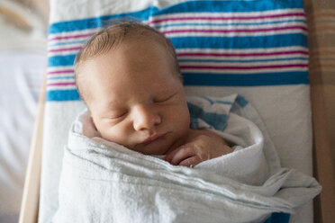 Close-up of baby boy sleeping in crib at hospital - CAVF43069