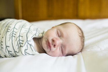 Close-up of baby boy sleeping on bed at home - CAVF43076