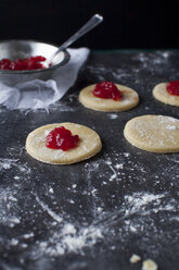 High angle view of dough with preserves on table - CAVF43164