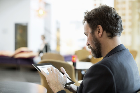 Businessman using digital tablet in hotel restaurant stock photo