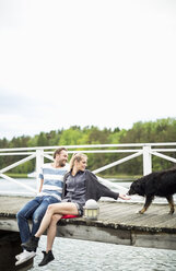 Couple with dog on pier - MASF05849