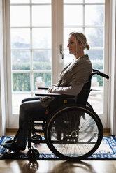 Side view of disabled woman in wheelchair at home - MASF05962