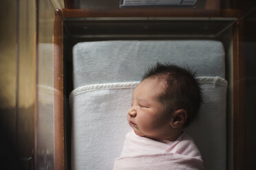 High angle view of newborn baby girl sleeping in crib at hospital - CAVF43468