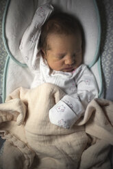 Overhead view of baby girl sleeping in crib at home - CAVF43472