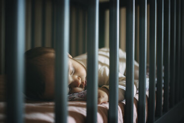 Close-up of baby girl sleeping in crib at home - CAVF43501