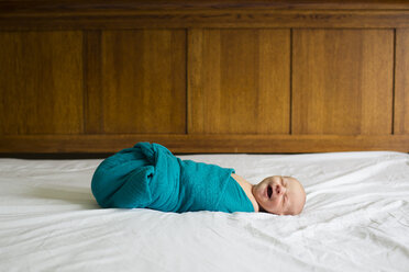 Baby boy sleeping on bed at home - CAVF43830