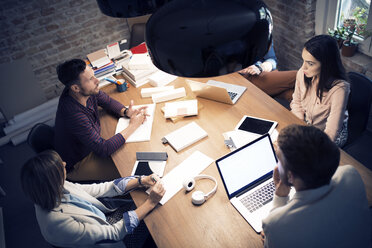 High angle view of colleagues having discussion in meeting - CAVF43917