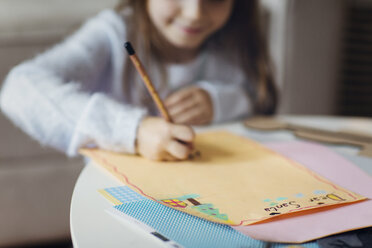 Girl drawing on paper at home during Christmas - CAVF43943