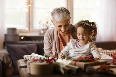 Grandmother and granddaughter drawing at home - CAVF43992