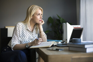 Thoughtful woman looking away while working at home - CAVF44043