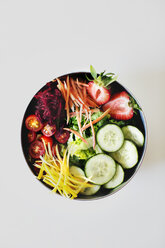 Overhead view of fresh salad in bowl against white background - CAVF44243