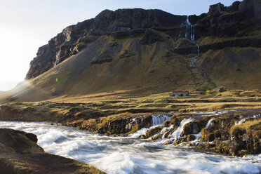 Scenic view of river and waterfalls against mountains - CAVF44623